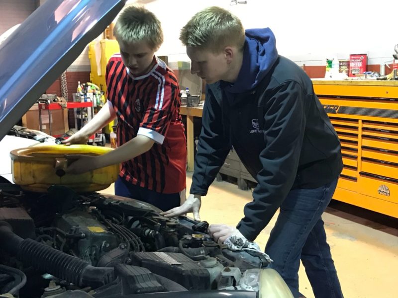 student learning to fix car